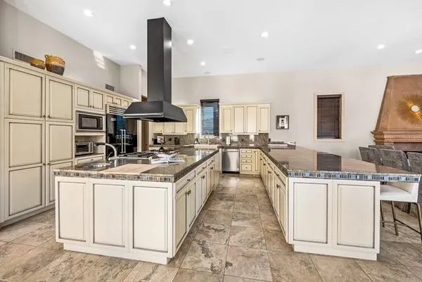 a kitchen with a sink stove and cabinets