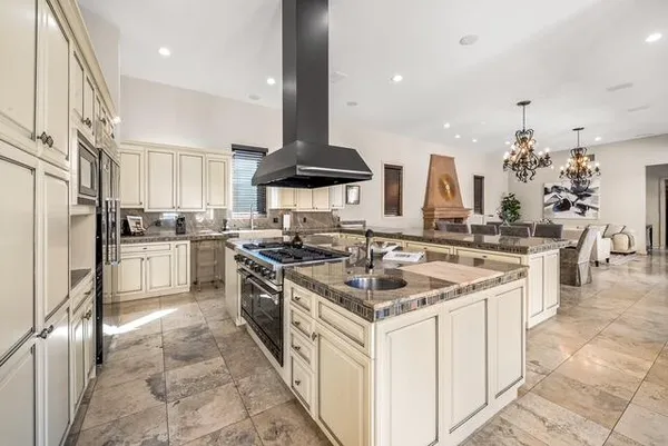 a kitchen with stainless steel appliances granite countertop a stove and a sink