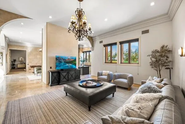 a living room with furniture a chandelier and a chandelier