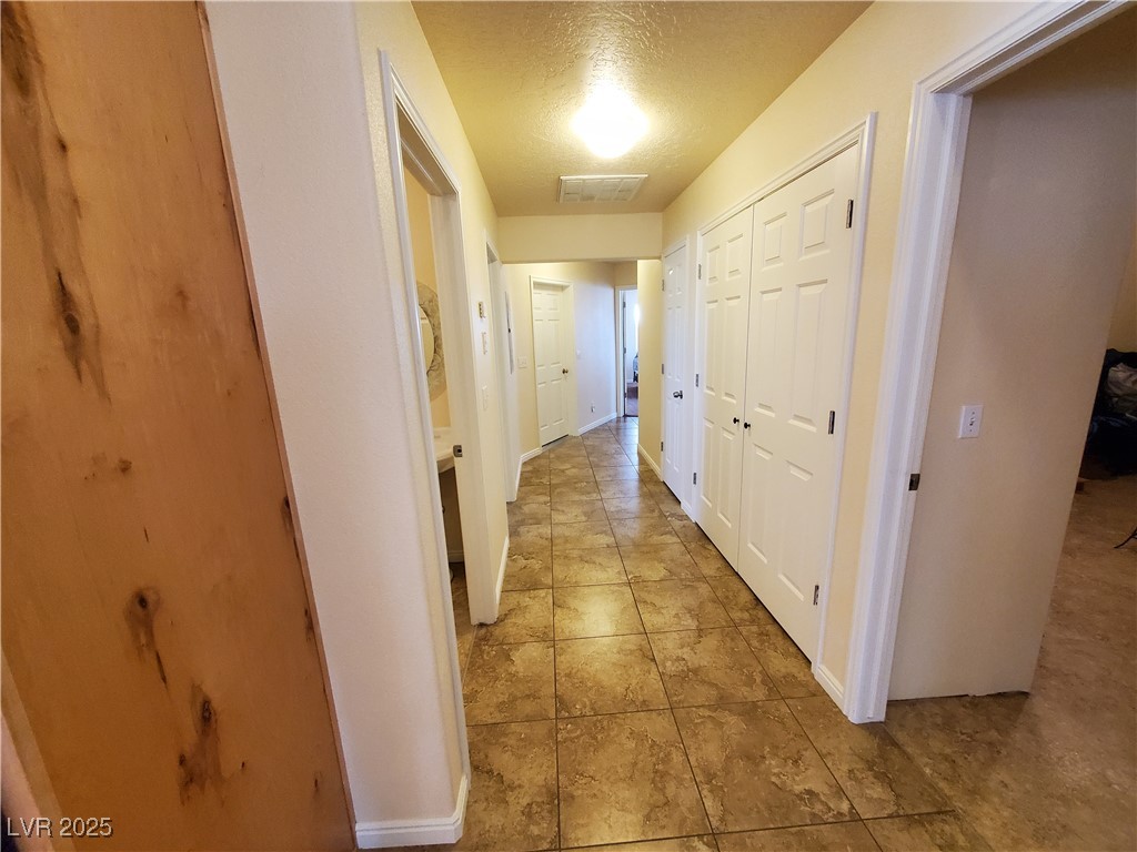 5272 Truman Lane Caliente, NV 89008 - Photo 22 of 39 Hall featuring a textured ceiling and baseboards