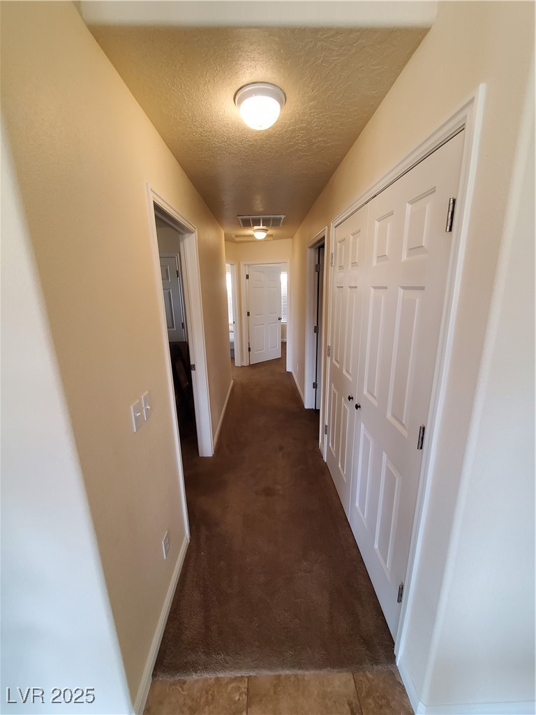 5272 Truman Lane Caliente, NV 89008 - Photo 23 of 39 Corridor with a textured ceiling, baseboards, and carpet