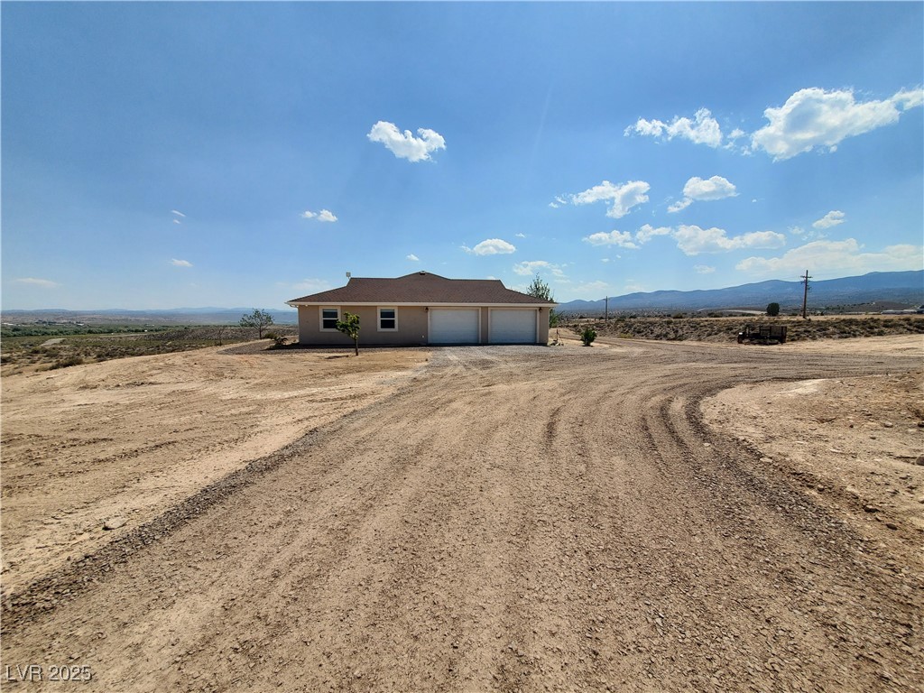 5272 Truman Lane Caliente, NV 89008 - Photo 32 of 39 Ranch-style home featuring driveway, a garage, and a mountain view
