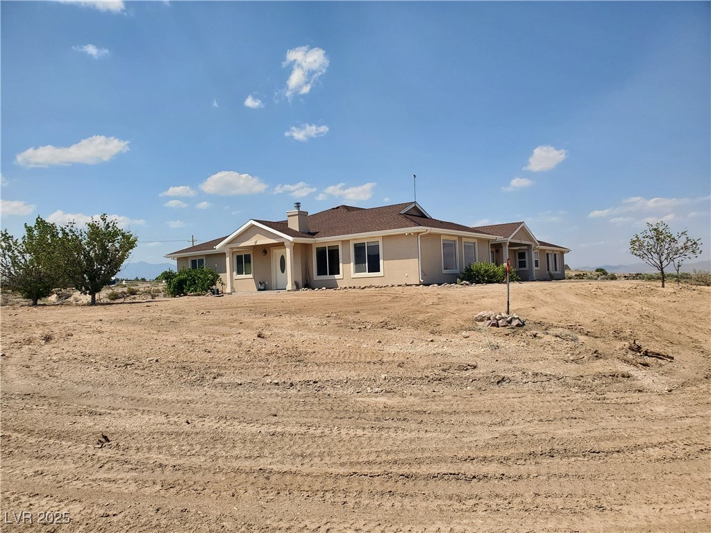 5272 Truman Lane Caliente, NV 89008 - Photo 35 of 39 View of front of home with a chimney and stucco siding