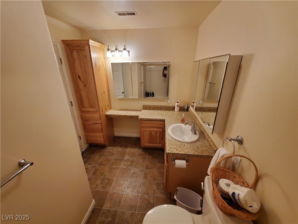 5272 Truman Lane Caliente, NV 89008 - Photo 4 of 39 Full bath with toilet, vanity, tile patterned flooring, an enclosed shower, and baseboards