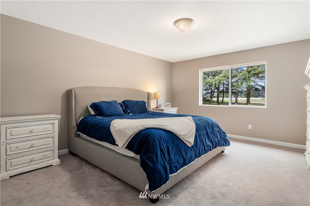 18221 Lawton Lane Southwest Rochester, WA 98579 - Photo 17 of 36 a bedroom with a bed and a window