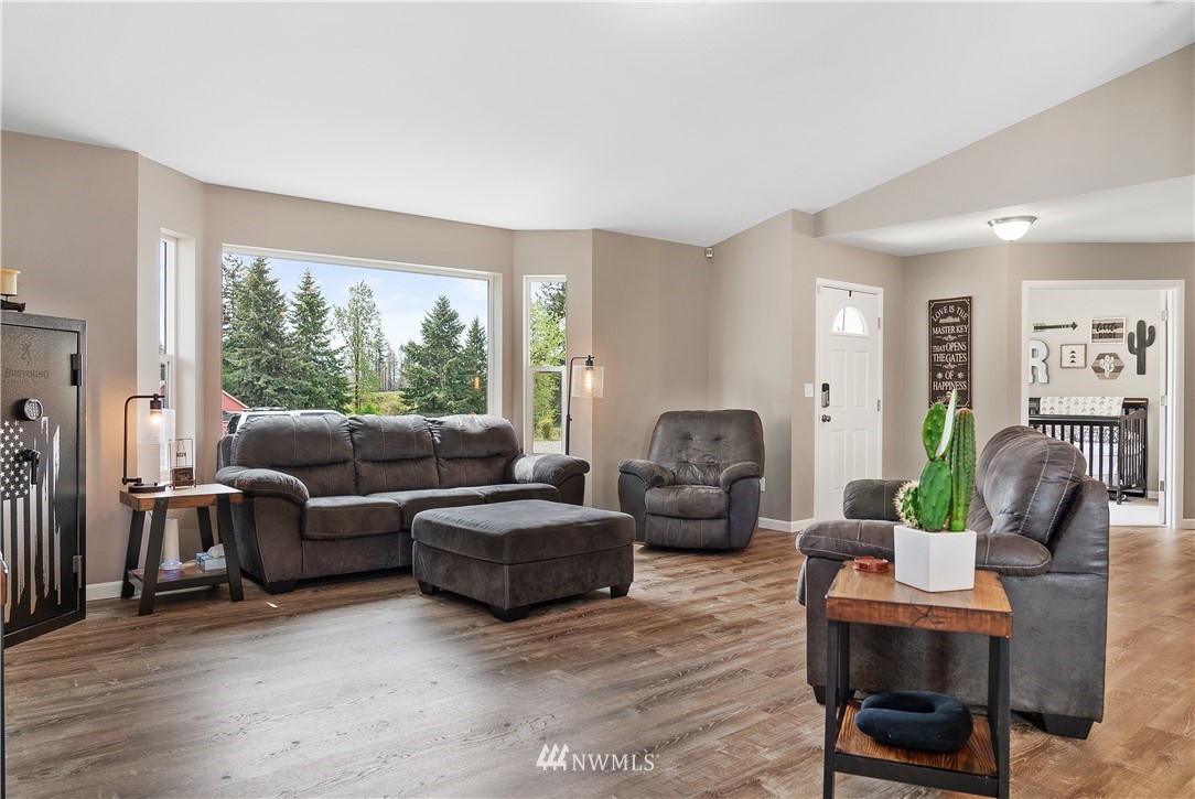 18221 Lawton Lane Southwest Rochester, WA 98579 - Photo 8 of 36 a living room with furniture and a large window