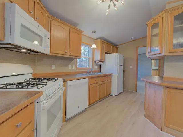 a kitchen with a stove a sink and a refrigerator