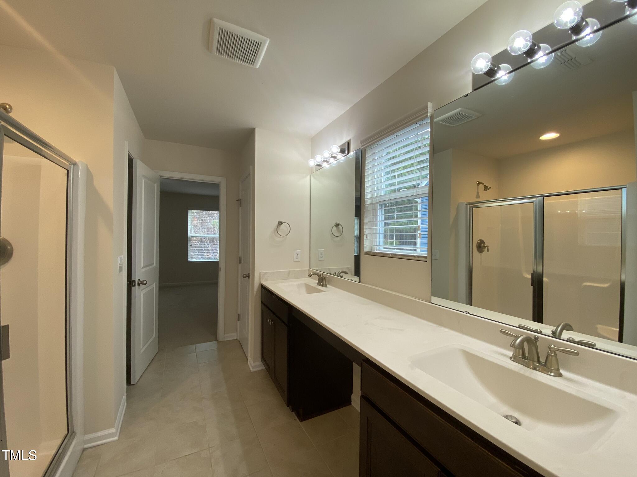 3545 Massey Ridge Court Raleigh, NC 27616 - Photo 26 of 38 a bathroom with a double vanity sink and a mirror