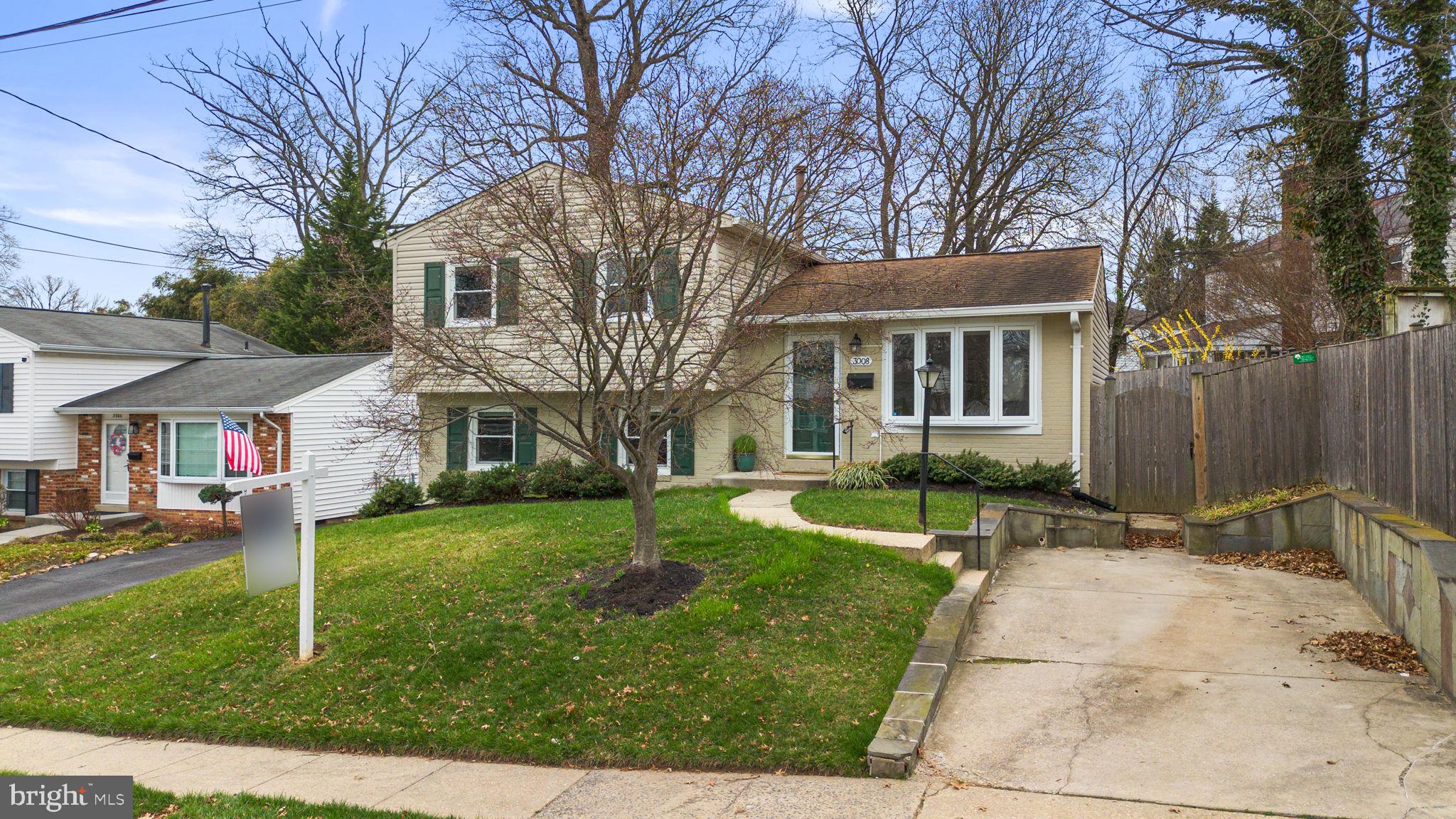 3008 Hardy Avenue Silver Spring, MD 20902 - Photo 1 of 29 a front view of a house with a yard and trees
