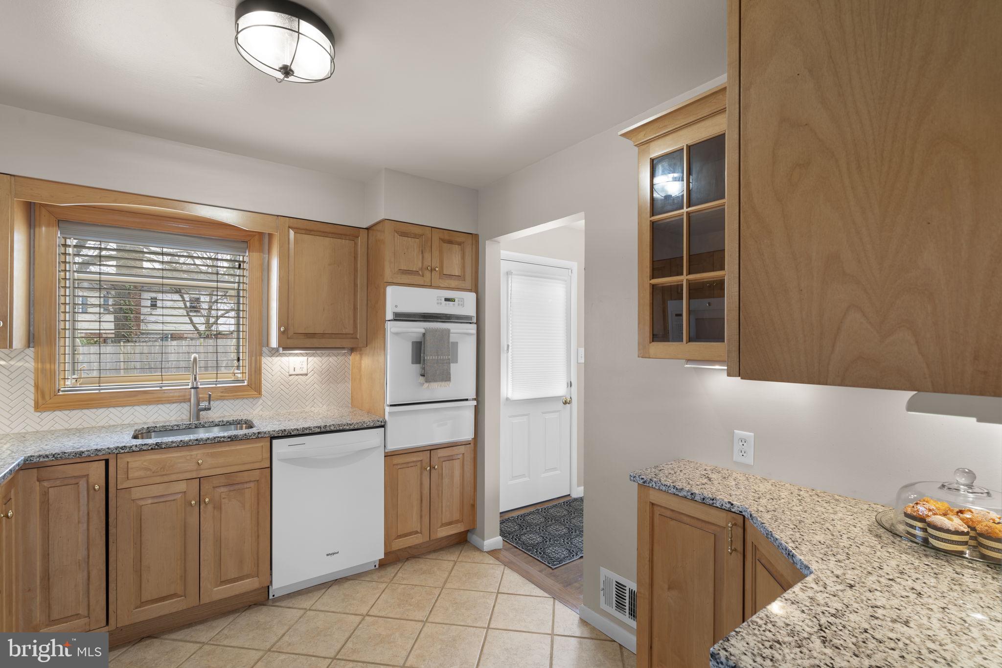 3008 Hardy Avenue Silver Spring, MD 20902 - Photo 12 of 29 a kitchen with white cabinets and sink