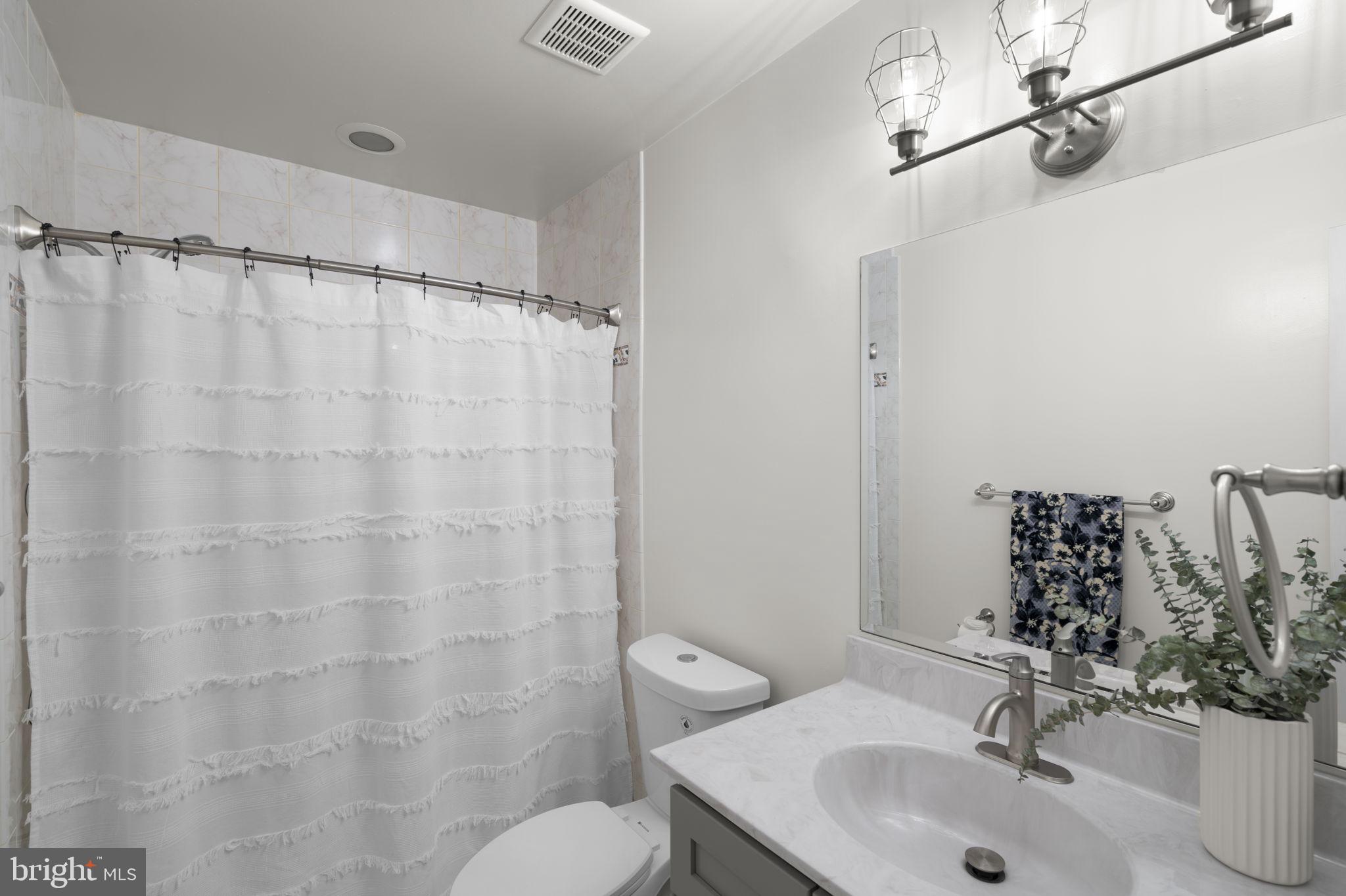 3008 Hardy Avenue Silver Spring, MD 20902 - Photo 16 of 29 a bathroom with a sink and a mirror