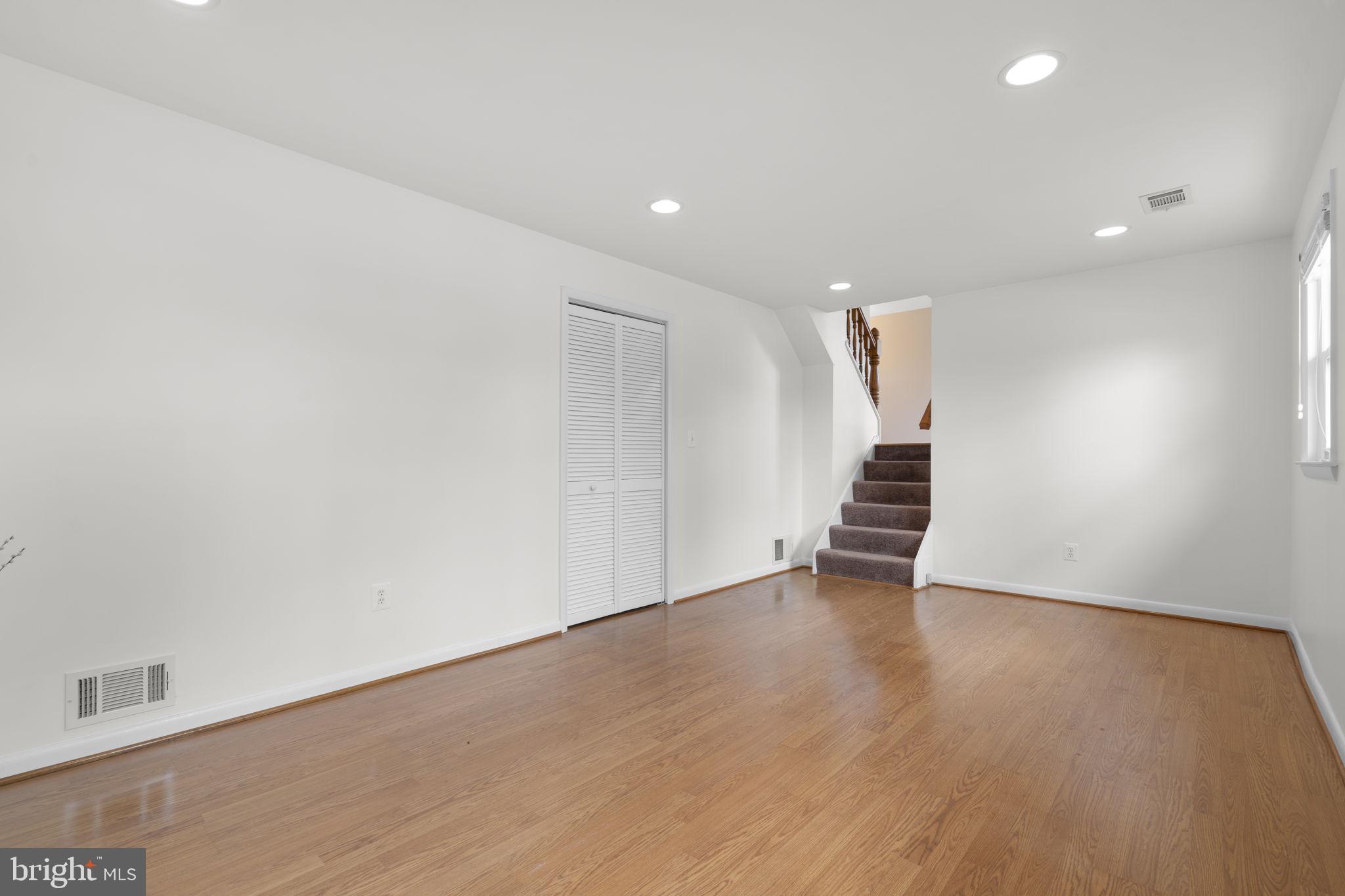 3008 Hardy Avenue Silver Spring, MD 20902 - Photo 23 of 29 a view of an empty room with wooden floor and stairs