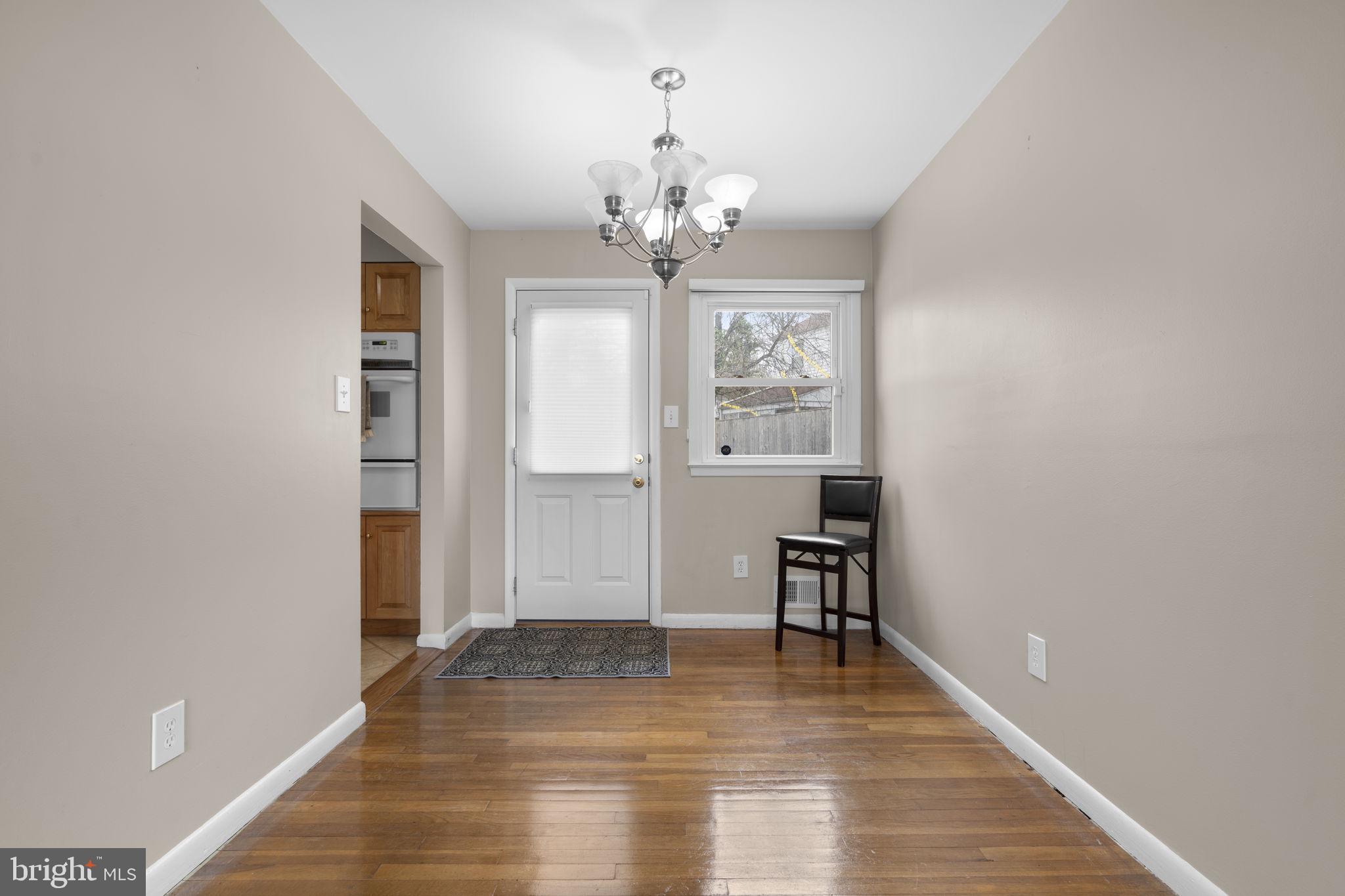 3008 Hardy Avenue Silver Spring, MD 20902 - Photo 6 of 29 a view of an empty room with window and wooden floor