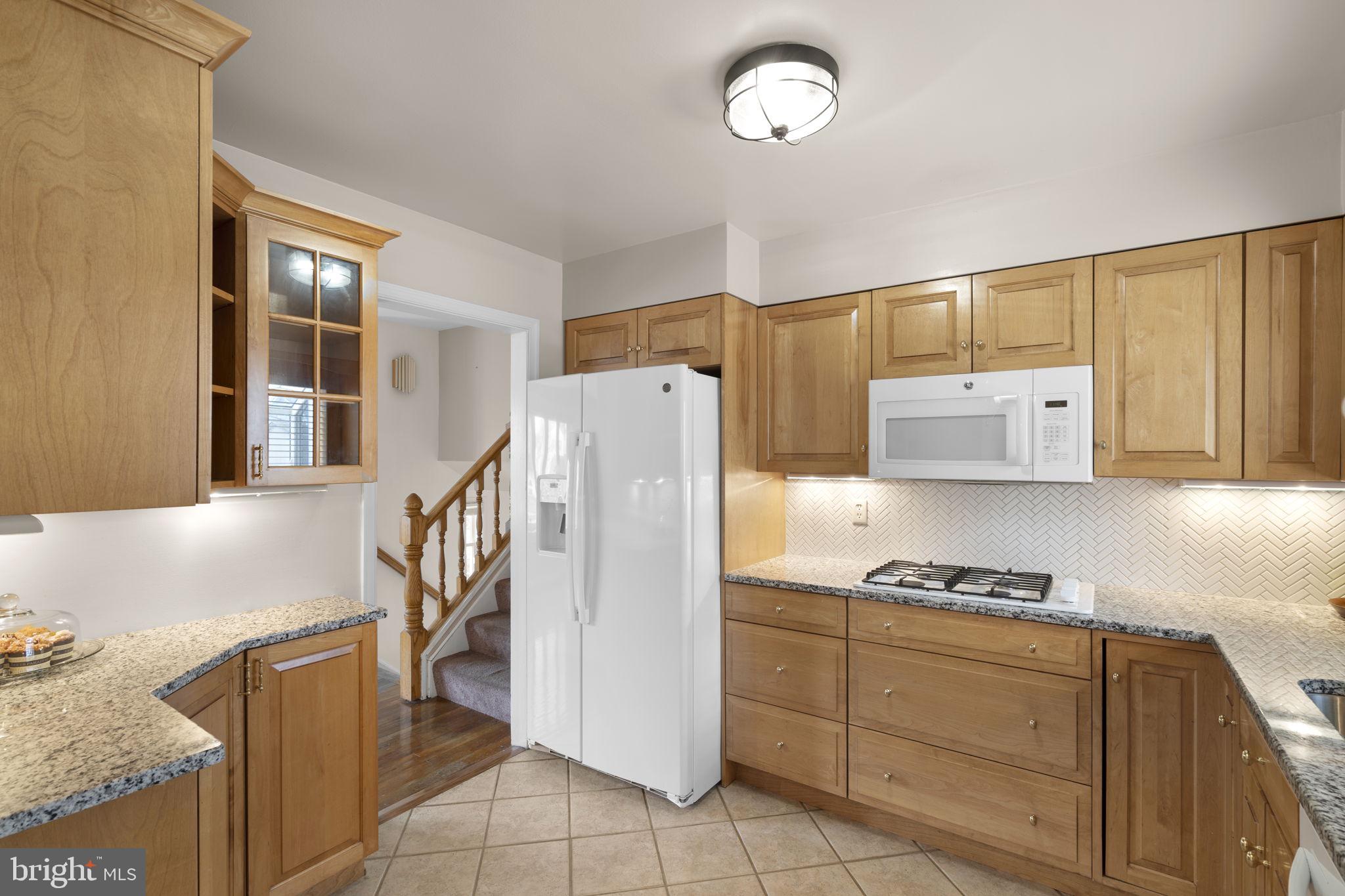 3008 Hardy Avenue Silver Spring, MD 20902 - Photo 9 of 29 a kitchen with cabinets a refrigerator and a sink