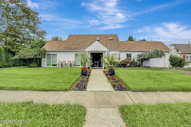 a front view of house with yard and green space
