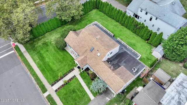 an aerial view of residential house with outdoor space and parking