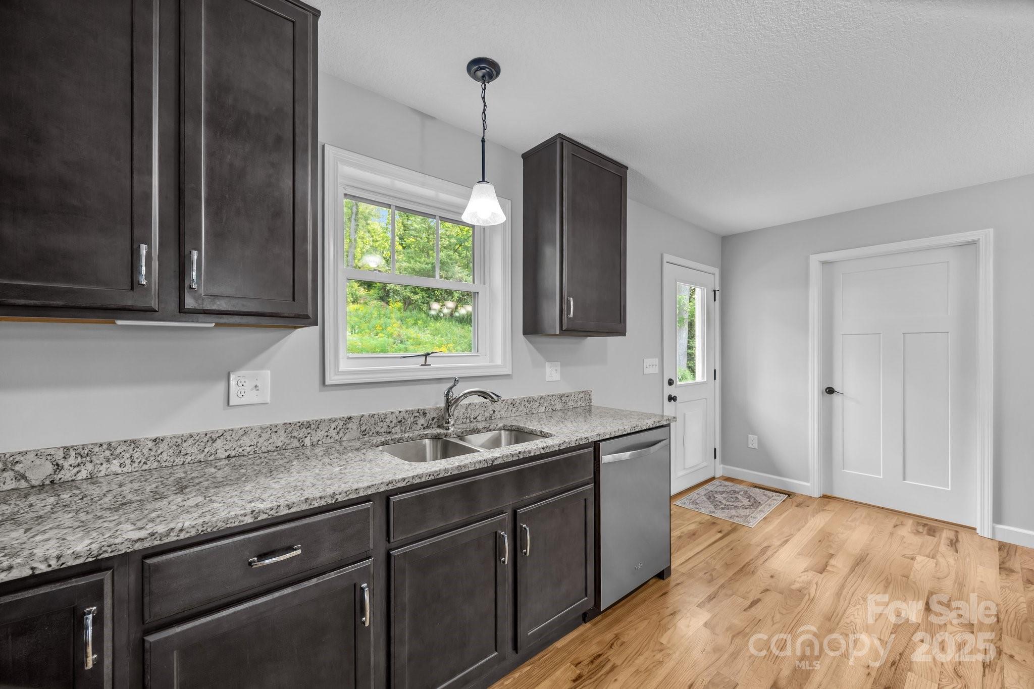 17 Laurel Road Arden, NC 28704 - Photo 12 of 45 a kitchen with a sink stove and cabinets