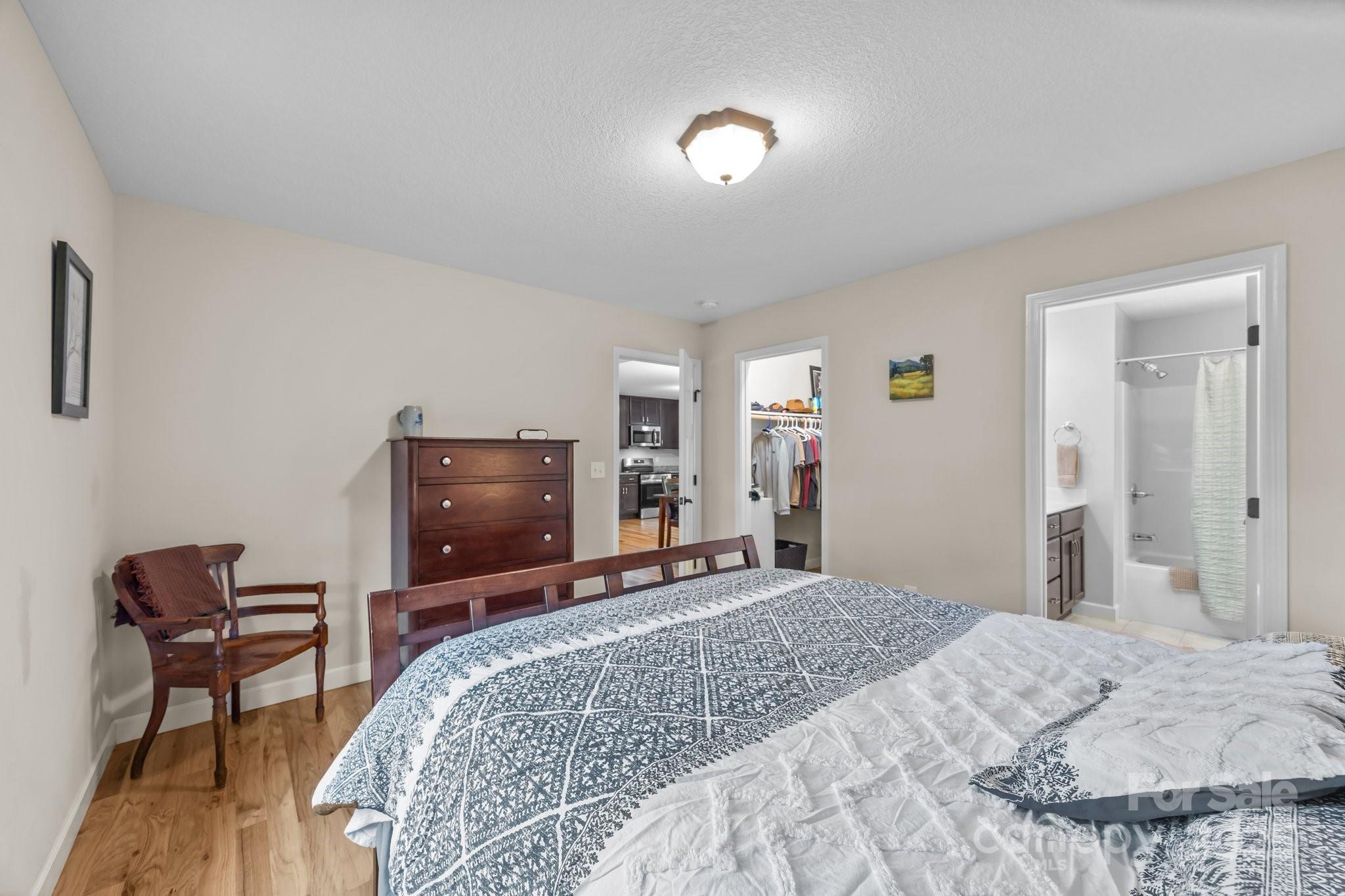 17 Laurel Road Arden, NC 28704 - Photo 16 of 45 a bedroom with a bed and a chair