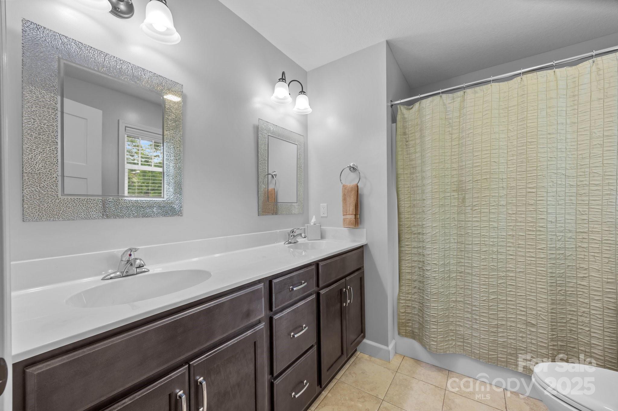 17 Laurel Road Arden, NC 28704 - Photo 17 of 45 a bathroom with a double vanity sink toilet and a mirror
