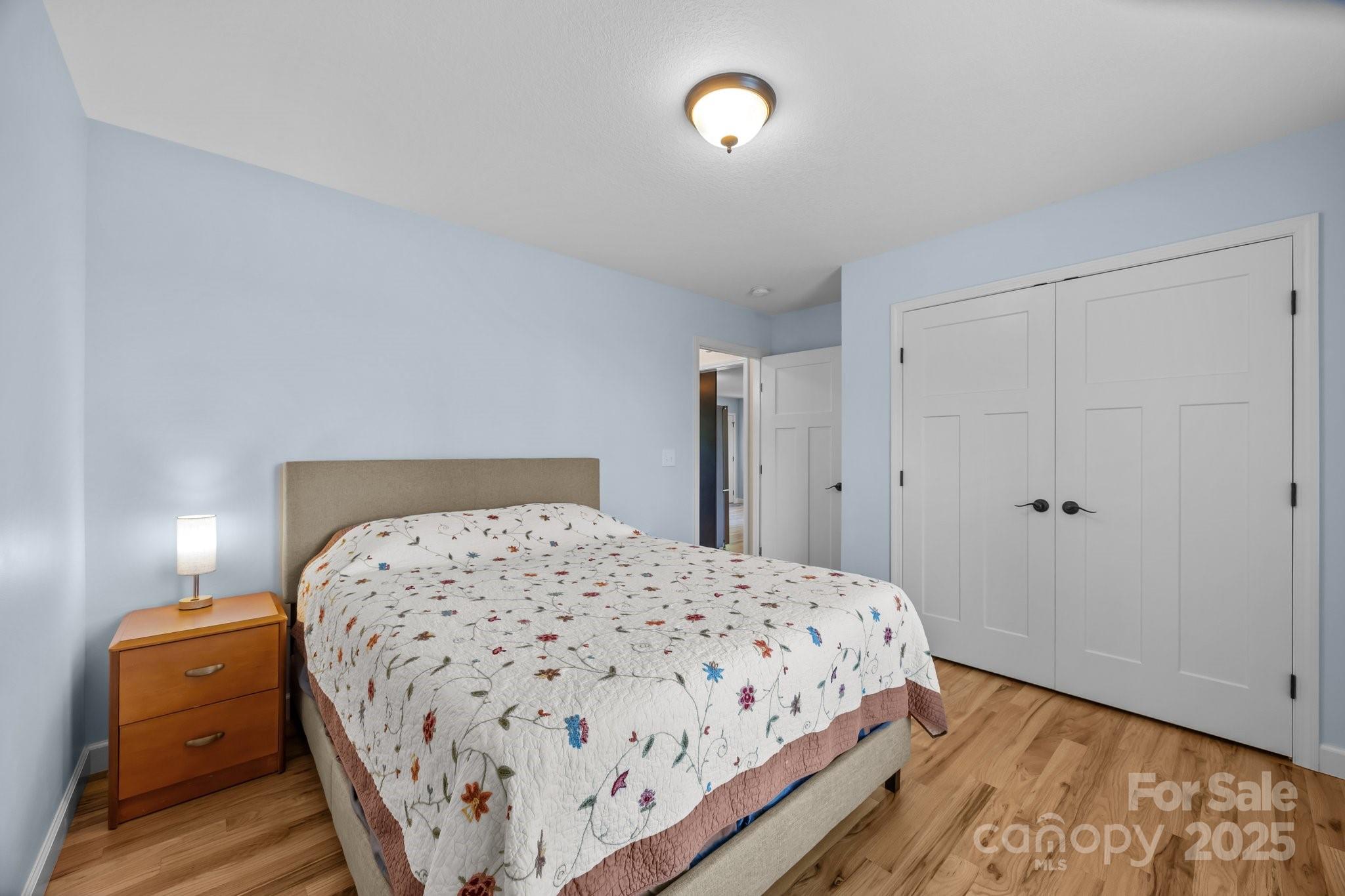 17 Laurel Road Arden, NC 28704 - Photo 18 of 45 a bedroom with a bed and a lamp