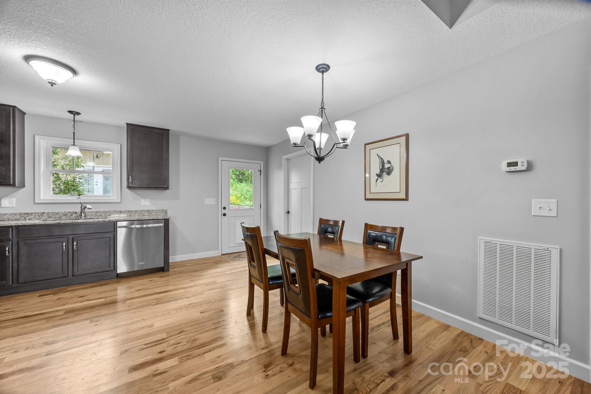 17 Laurel Road Arden, NC 28704 - Photo 22 of 45 a view of a dining room with furniture and wooden floor
