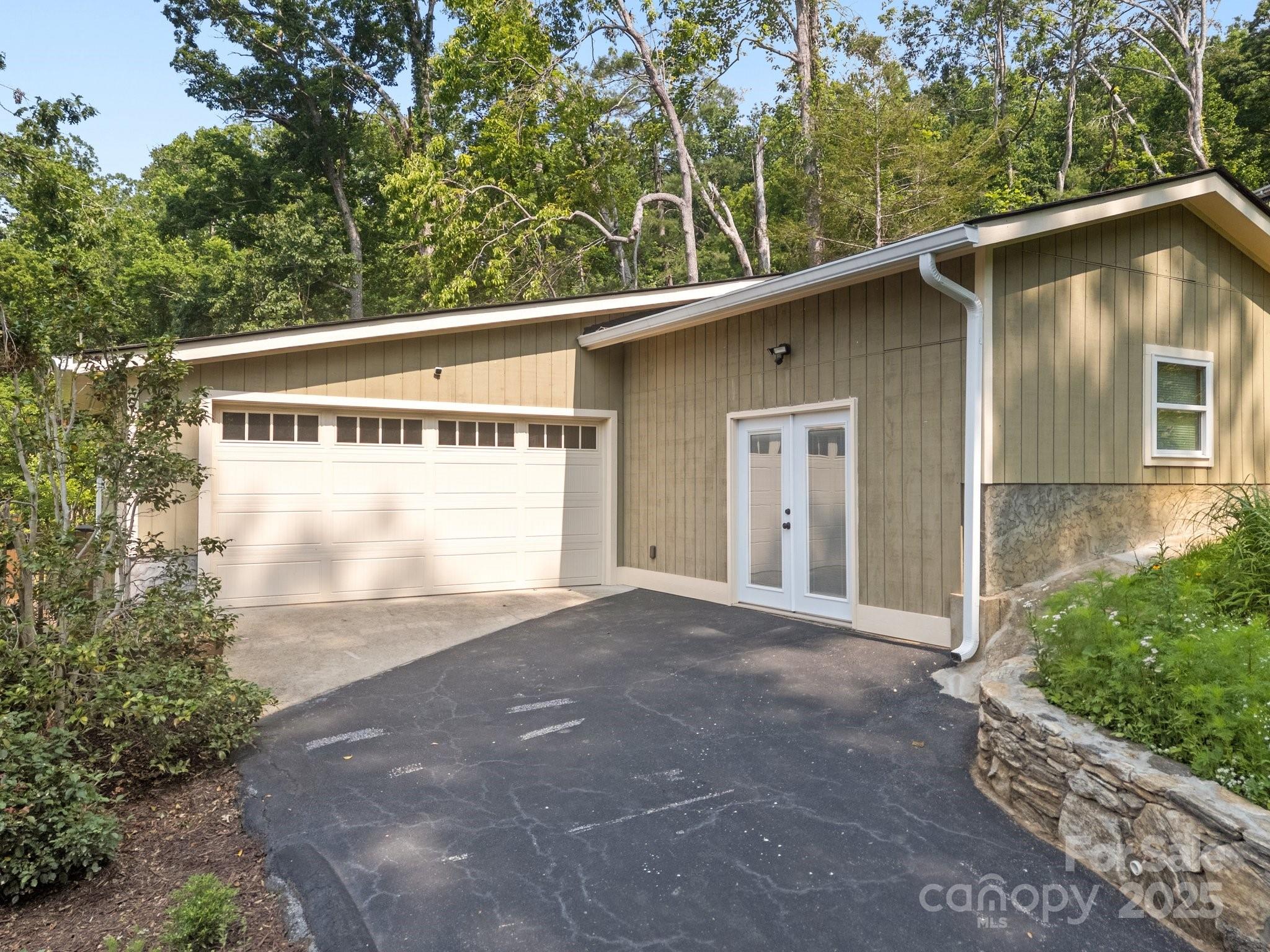 17 Laurel Road Arden, NC 28704 - Photo 26 of 45 a front view of a house with a yard and garage