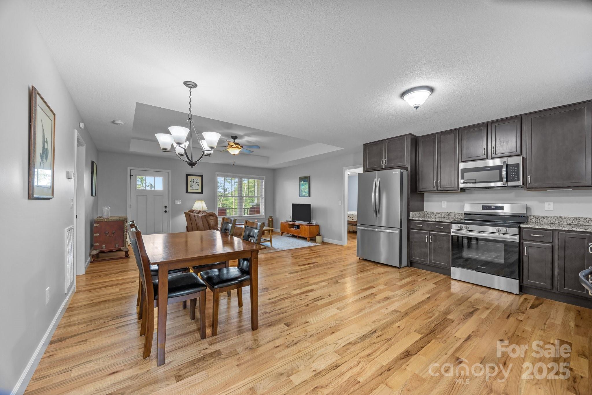 17 Laurel Road Arden, NC 28704 - Photo 8 of 45 a view of a dining room with furniture a chandelier and wooden floor
