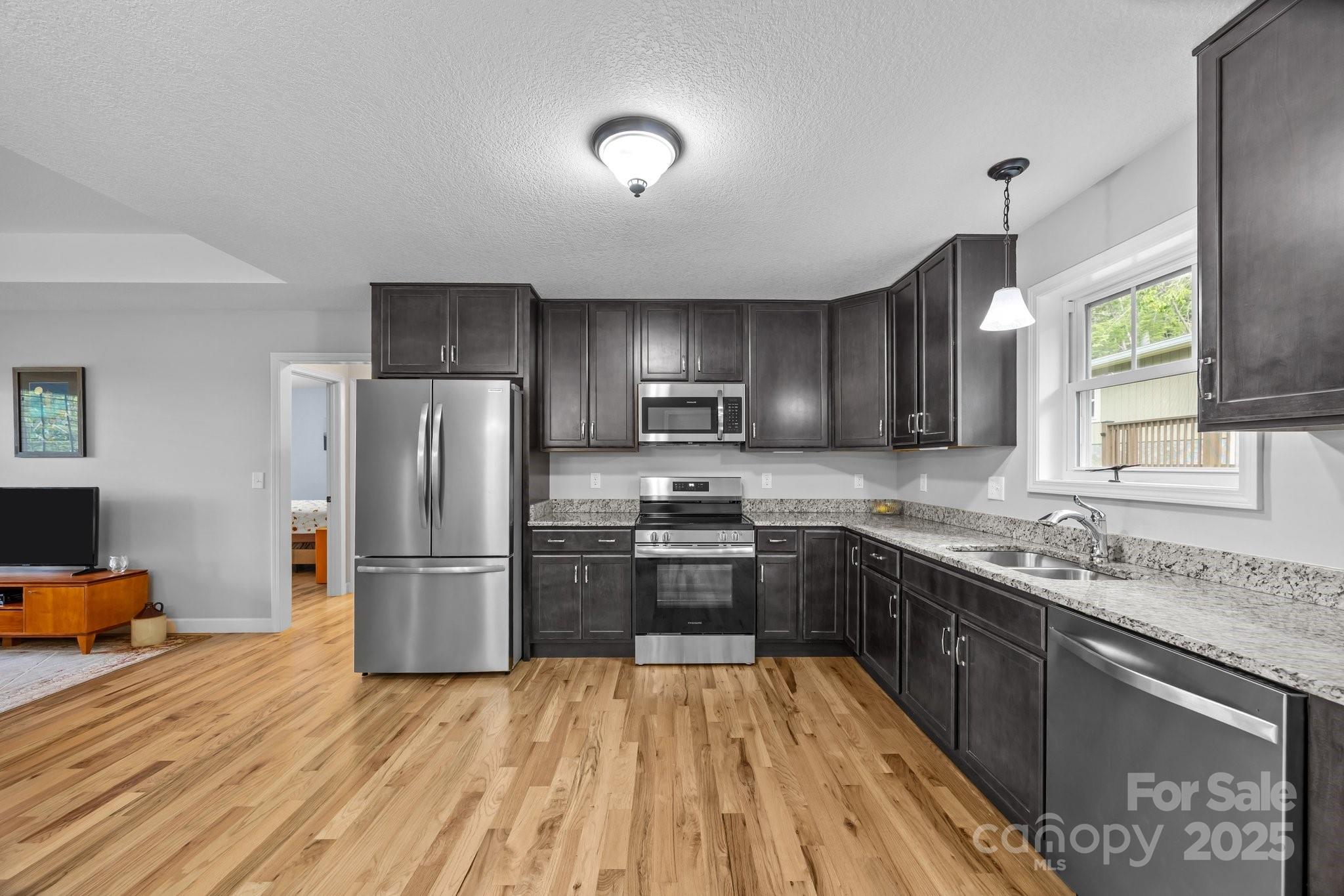 17 Laurel Road Arden, NC 28704 - Photo 9 of 45 a kitchen with refrigerator cabinets and wooden floor