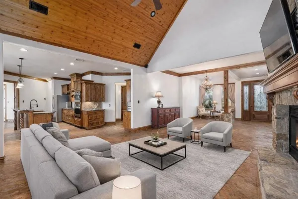 a living room with furniture a flat screen tv and a fireplace