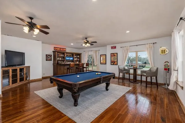a living room with furniture a wooden floor and flat screen tv