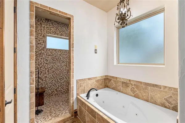 a bathroom with a bathtub and shower