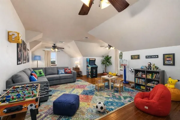 a living room with furniture toys and a flat screen tv
