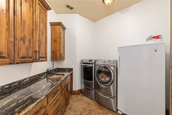 a utility room with sink dryer and washer