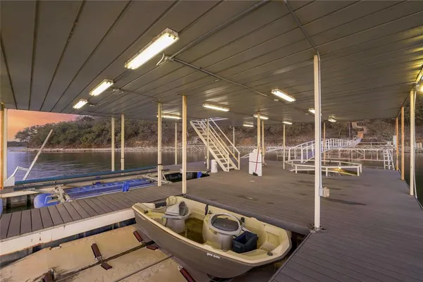 a view of roof deck with table and chairs