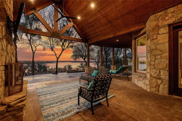 a patio with glass top table and chairs
