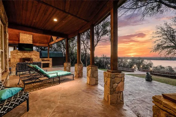 a view of a patio with a dining table and chairs with wooden floor