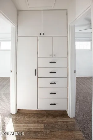 a view of empty room with wooden floor