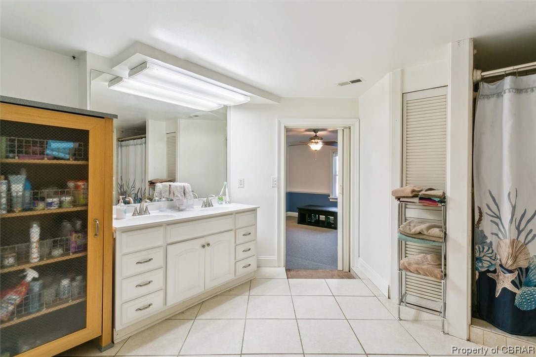 3255 Providence Road Hayes, VA 23072 - Photo 25 of 46 Primary bathroom featuring double sink, tile flooring, ceiling fan, and oversized vanity