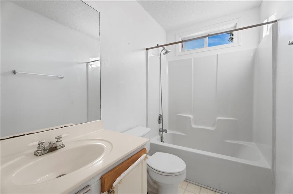 6644 Virlyn B Smith Road Fairburn, GA 30213 - Photo 12 of 43 a bathroom with a sink toilet and shower