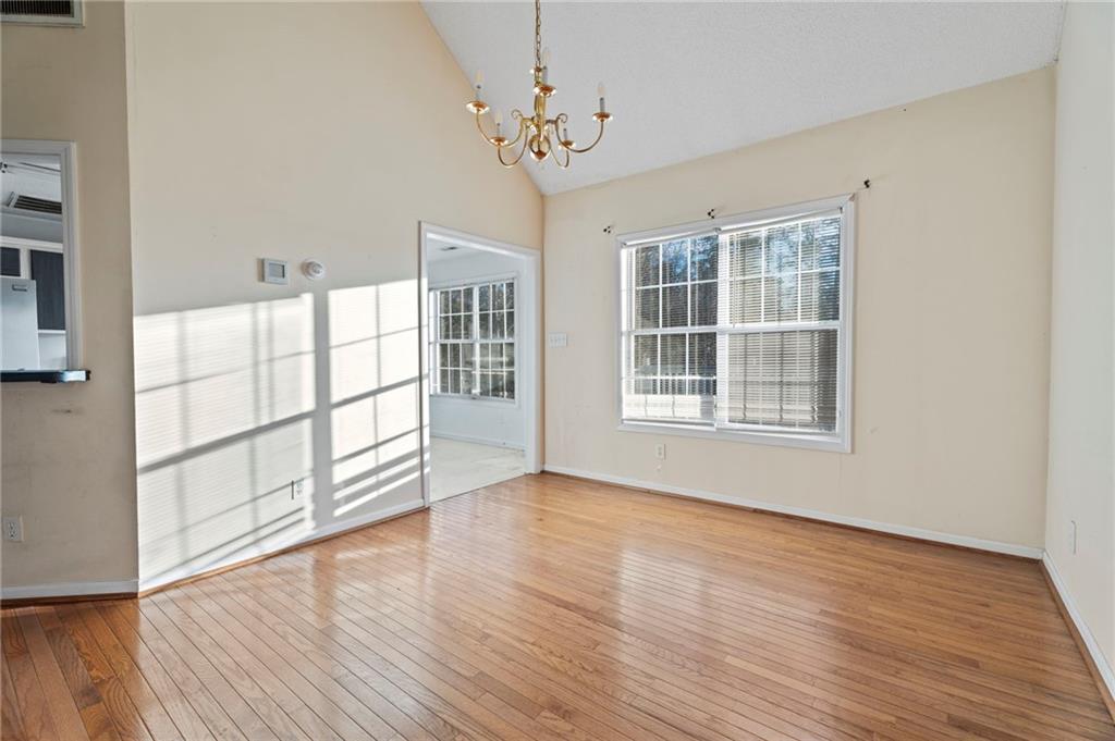 6644 Virlyn B Smith Road Fairburn, GA 30213 - Photo 15 of 43 wooden floor in an empty room with a window