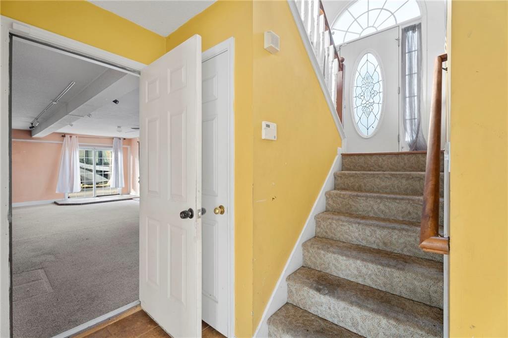 6644 Virlyn B Smith Road Fairburn, GA 30213 - Photo 28 of 43 a view of a hallway with wooden floor and entryway