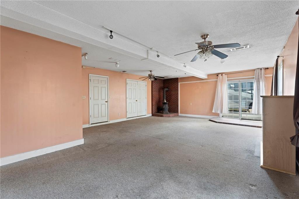 6644 Virlyn B Smith Road Fairburn, GA 30213 - Photo 30 of 43 a view of a livingroom with a ceiling fan and window
