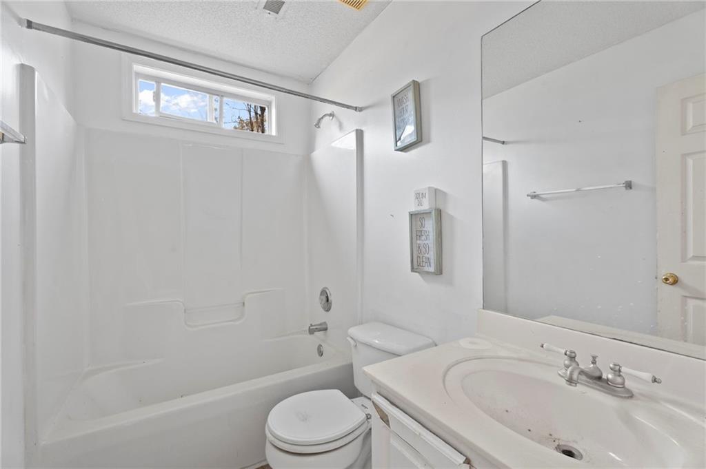 6644 Virlyn B Smith Road Fairburn, GA 30213 - Photo 32 of 43 a bathroom with a toilet sink shower and bathtub