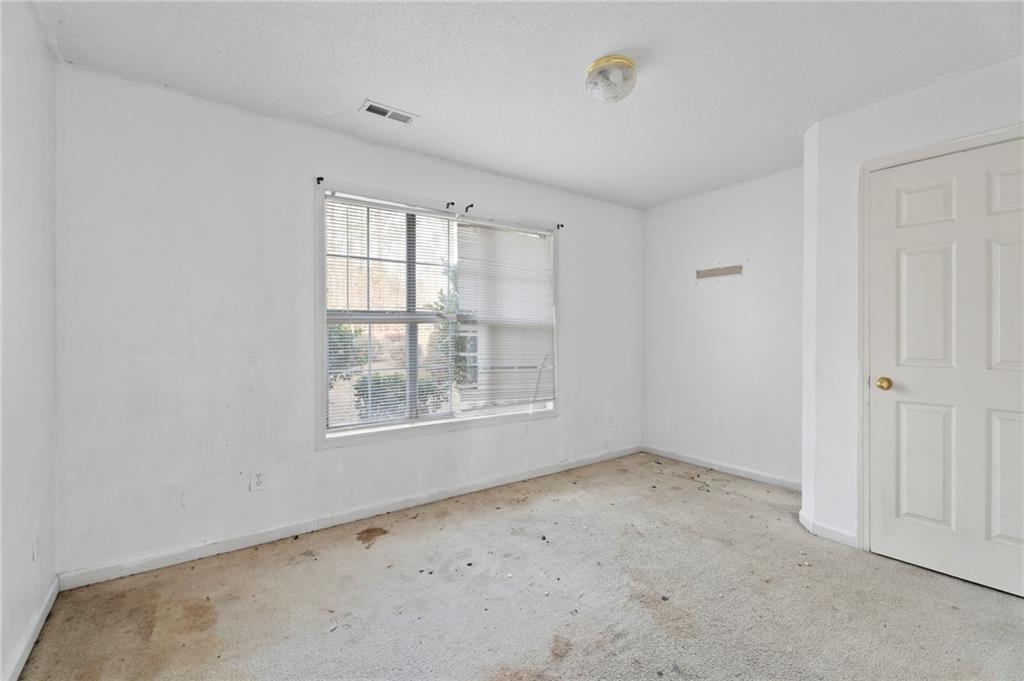 6644 Virlyn B Smith Road Fairburn, GA 30213 - Photo 33 of 43 an empty room with windows