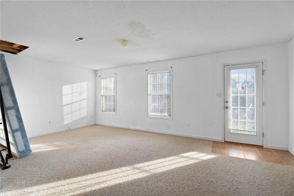 6644 Virlyn B Smith Road Fairburn, GA 30213 - Photo 35 of 43 an empty room with windows