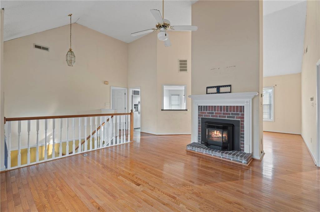 6644 Virlyn B Smith Road Fairburn, GA 30213 - Photo 8 of 43 a view of a livingroom with wooden floor a fireplace and a window