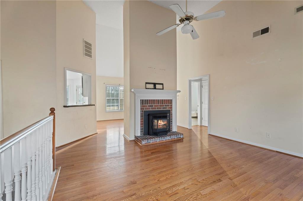 6644 Virlyn B Smith Road Fairburn, GA 30213 - Photo 9 of 43 a view of a livingroom with wooden floor a fireplace and window