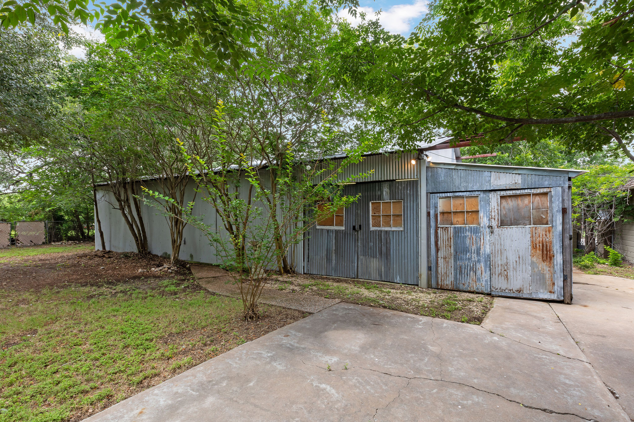 948 Maple Street Lockhart, TX 78644 - Photo 34 of 40 Corrugated metal siding envelops this robust shed, offering ample outdoor storage.