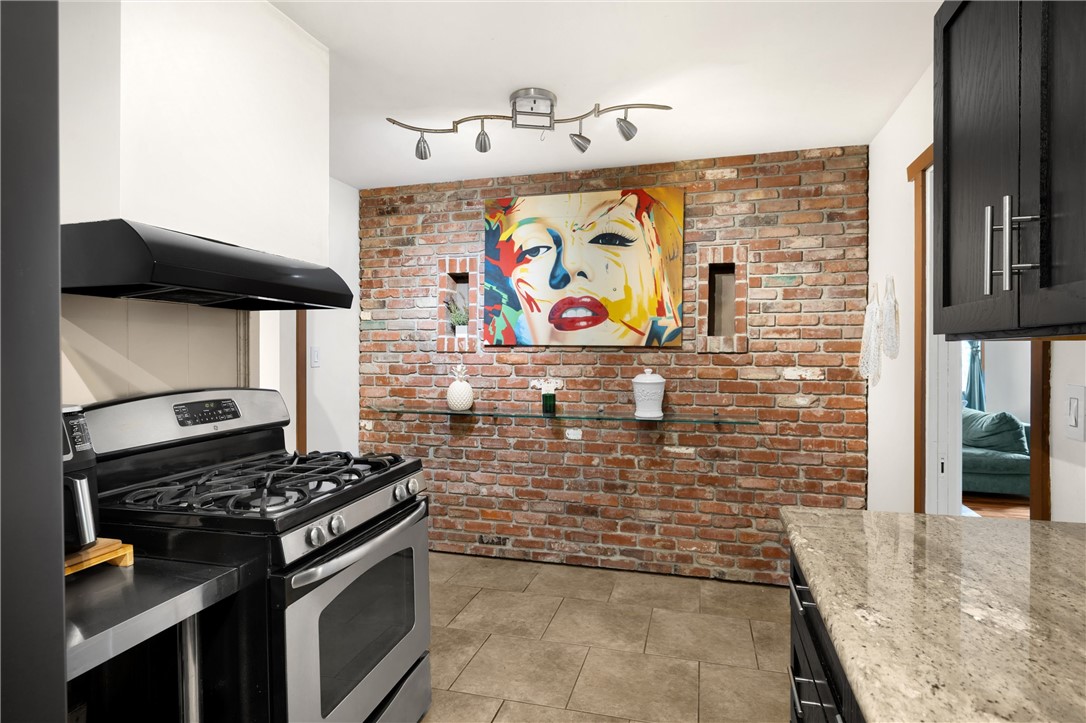 6957 Lindley Avenue Reseda, CA 91335 - Photo 11 of 27 a kitchen with stove and cabinets
