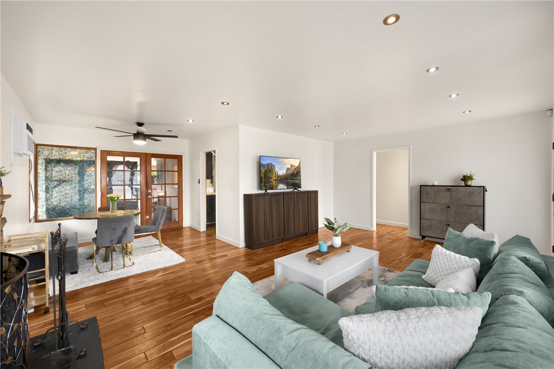 6957 Lindley Avenue Reseda, CA 91335 - Photo 5 of 27 a living room with furniture and wooden floor